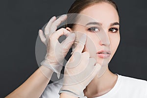 Portrait of a young girl with a mask removed from her face.