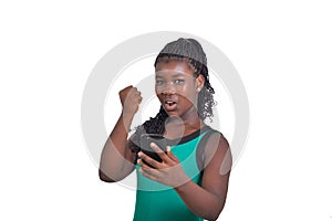 Portrait of a young girl with mobile phone showing victory gesture