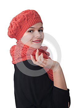 Portrait of a young girl in an openwork orange beret and handmade scarf on a white background