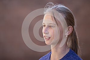 Portrait young girl outdoors, close up