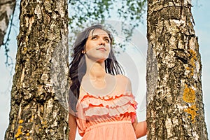 Portrait of a young girl in a park forest with birch trees