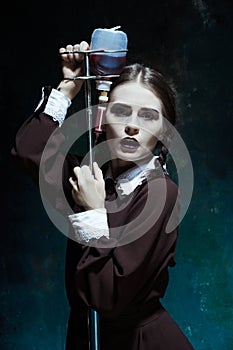 Portrait of a young girl in school uniform as a vampire woman