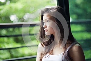 Portrait of Young girl sitting near the window