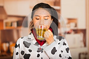 Portrait of young girl with skin problem drinking some tea