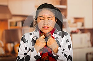 Portrait of young girl with skin problem with a red wool sweater around his neck