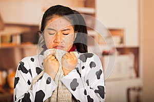 Portrait of young girl with skin problem with a wool sweater around his neck