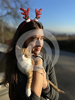 Portrait of young  girl with small kitten