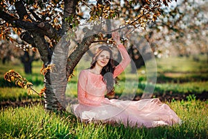 Portrait of a young girl in spring orchard