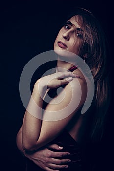 Portrait of young girl in studio on black background