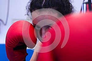 Portrait of young girl training boxing