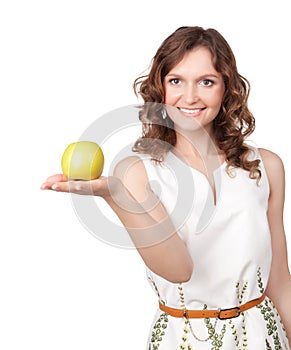 Portrait of young girl which gives of a green apple