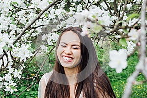 Portrait of young girl in white dress with flowers