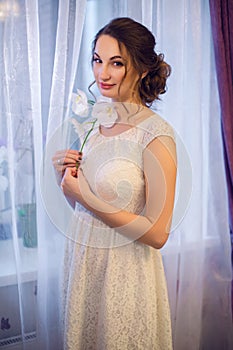 Portrait of a young girl in white dress with an Orchid flower