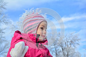 Portrait of young girl in winter clothes and colorful woolen hat