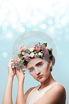 Portrait of a young girl in a wreath of roses