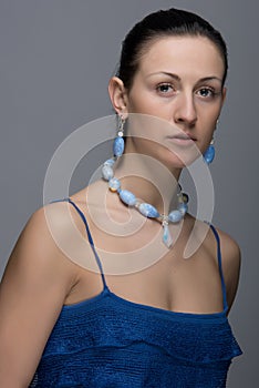 Portrait of young lady with earrings and necklace