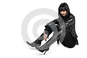 Portrait of young goth woman in lace-up boots photo