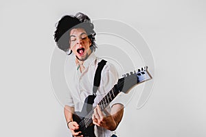 Portrait of young guitarist with gesture on his face