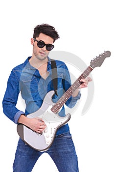 Portrait of a young guitarist playing an electric guitar