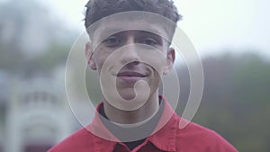 Portrait of a young guy with curly red hair Close up of guy`s face Emotions on the face of a young guy close-up