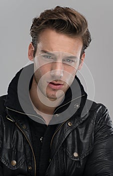 Portrait of a young guy over gray background