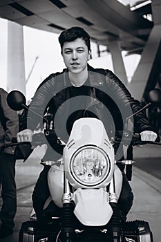 Portrait young guy posing on the motorcycle, fashion men