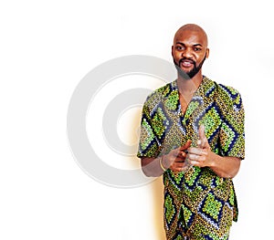 Portrait of young handsome african man wearing bright green national costume smiling gesturing, entertainment stuff