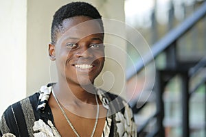 Portrait of young handsome afro black man posing outdoor