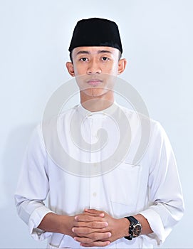 Portrait of young handsome Asian muslim man