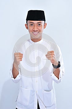 Portrait of young handsome Asian muslim man smile to enjoy the eid mubarak