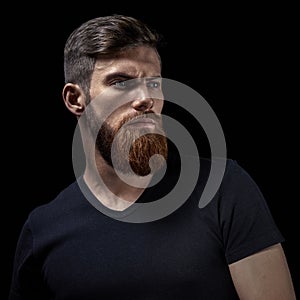 Portrait of young handsome bearded man looking forward