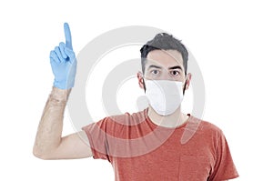 Portrait of young handsome beautiful man with face mask and blue gloves pointing finger up. 2019-nCo