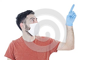 Portrait of young handsome beautiful man with face mask and blue gloves pointing finger up, isolated on white background.