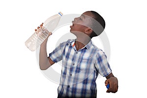 portrait of a young handsome boy drinking water from a plastic bottle
