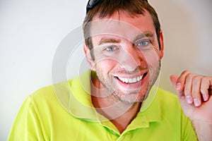 Portrait of young handsome caucasian man smiling and looking at camera