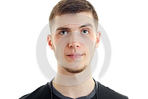 Portrait of a young handsome guy who surprised looks into a camera close-up