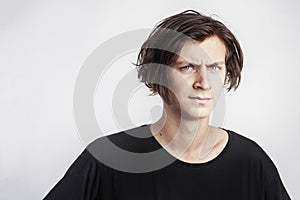 Portrait of young handsome hipster man look serious stressful, black t-shirt, white background