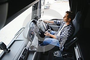 Portrait of a young handsome Indian truck driver. The concept of logistics and freight transportation.