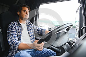 Portrait of a young handsome Indian truck driver. The concept of logistics and freight transportation.