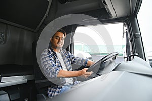 Portrait of a young handsome Indian truck driver. The concept of logistics and freight transportation.