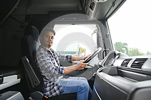 Portrait of a young handsome Indian truck driver. The concept of logistics and freight transportation.