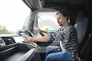 Portrait of a young handsome Indian truck driver. The concept of logistics and freight transportation.