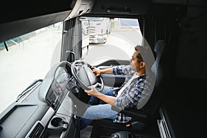 Portrait of a young handsome Indian truck driver. The concept of logistics and freight transportation.