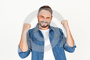 Portrait of young handsome man with beard wearing casual clothes on white background very happy and excited doing winner gesture