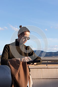 Portrait of young handsome man communicatin with his smart watch over a voice call under blue sky in the afternoon light