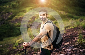 Portrait of young handsome man holding trekking pole at nature,Happy and smiling,Travel at outdoor