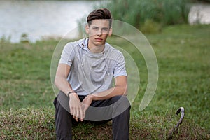 Portrait of a young handsome man outdoors. Teenager