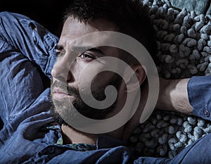 Portrait of young handsome serious man in a hammock.