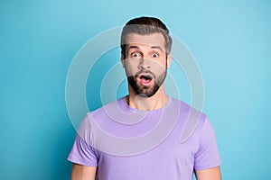 Portrait of young handsome shocked amazed surprised guy with open mouth look camera isolated on blue color background