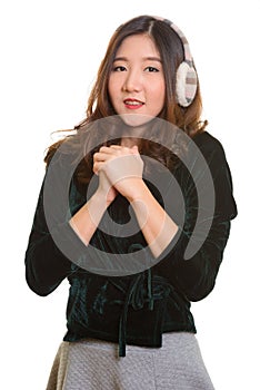 Portrait of young happy Asian woman feeling cold